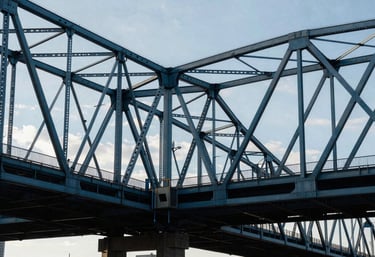 A wide shot of a modern city bridge in North America, symbolizing connectivity and network strength, in steel blue and dark navy tones.