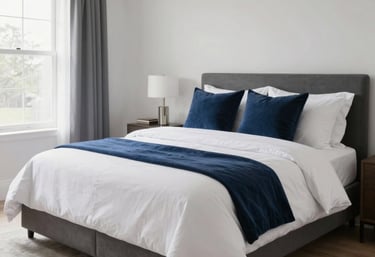 Wide shot of a perfectly cleaned North American bedroom with a freshly made bed featuring white linens and navy blue throw pillows. The room is spacious, bright, and serene, reflecting high-quality service and a seamless customer experience.