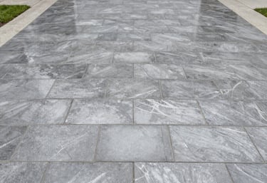 Before and after view of an interlock tile patio transformed by sealing.