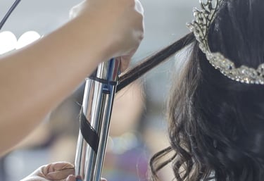 Estilista profesional que utiliza un rizador para peinar el cabello oscuro de una novia 