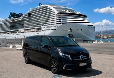 Black Mercedes V-Class luxury minivan parked by the MSC World Europa cruise ship in Marseille port.