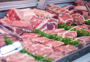 A Variety of Raw Meat arranged out on a market stall