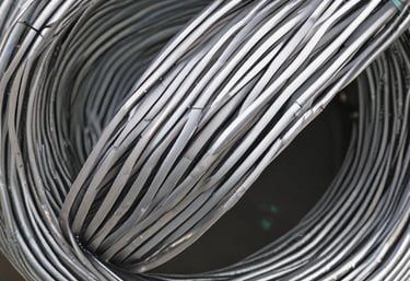 PVC coated wire mesh being inspected in a factory setting.