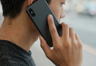A friendly Junk Kings team member helping a customer load junk into a truck on a sunny day.