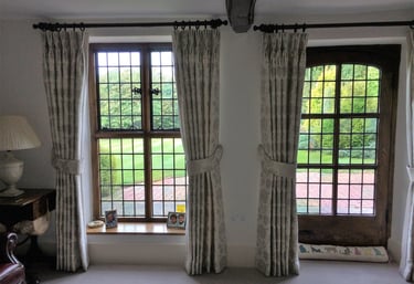 Bespoke curtains with double pleats and padded tie backs in the same fabric