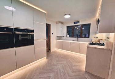 Moern all white kitchen with back lighting on cupboard storage
