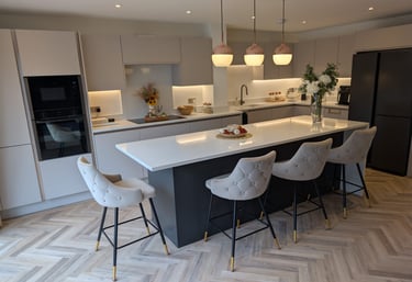 white modern kitchen, with flowers and comfortable stools