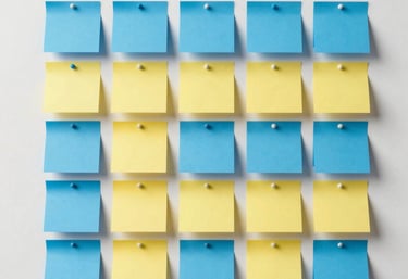 Photography of a clean, minimalist wall with several blue and yellow post-its arranged in a neat grid. Represents organization and MoSCoW prioritization.