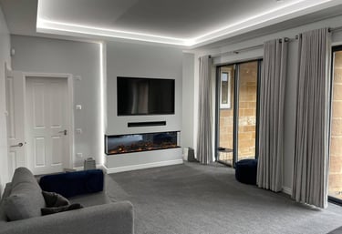 Sleek media wall in living room with bespoke lighting