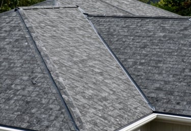 A freshly completed residential roof with clean flashing and gutters, set against a backdrop of green trees, North American / US.