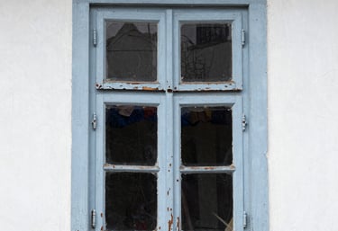 Laser cleaning in action on a historic stone façade with workers in protective gear nearby.