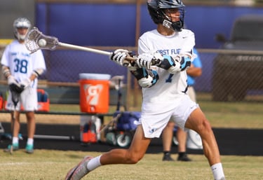 First Flight lacrosse player, Nathan Tsonev, with the ball.