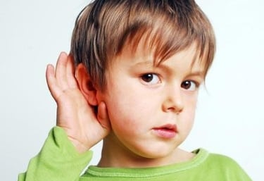 On Dr. Porro website, a boy puts his hand to his ear to improve his hearing or to listen carefully