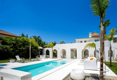 Rectangular Mediterranean pool with bright turquoise water and crisp white tiling for a clean coasta