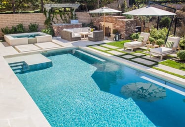 Contemporary pool with turquoise water, glassy mosaic tiling and crisp white concrete surrounds