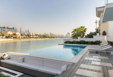 Luxury modern infinity-edge pool overlooking a waterfront city skyline, with sunken lounge seating a