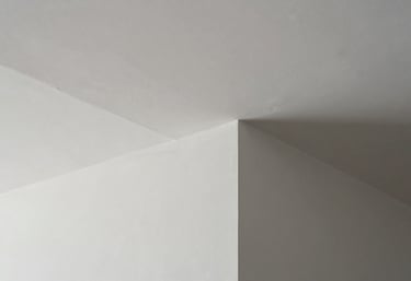 Detail of finished white drywall corners and seamless plastering in a newly renovated office in Northern Portugal, professional finish.