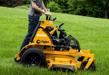 Wright Stander X mower with a team member mowing grass.