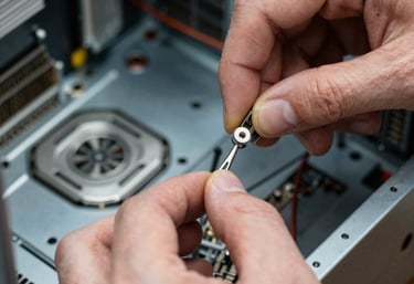 Technician carefully replacing a laptop screen in a cozy workshop.