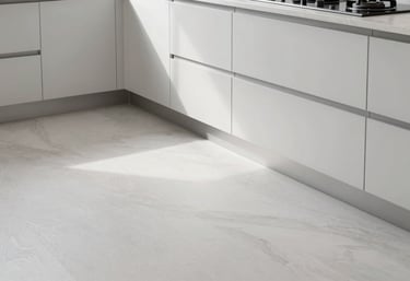 Photography of a high-end, newly finished kitchen floor and cabinetry, showcasing premium materials and cloud white and silver color palette in a bright home.