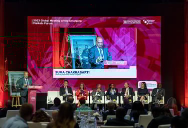 a man in a suit and tie is speaking into a microphone