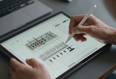 A close-up view of a professional Southeast Asian engineer's hands using a stylus on a high-tech tablet showing real-time construction progress charts. Clean, technical aesthetic with slate grey accents.