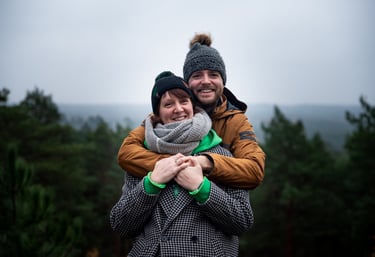 Portrait couleur d'un couple souriant et s'étreignant dans un cadre naturel
