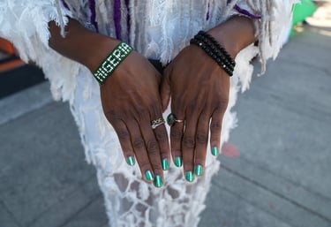 a woman with green nails and a white dress