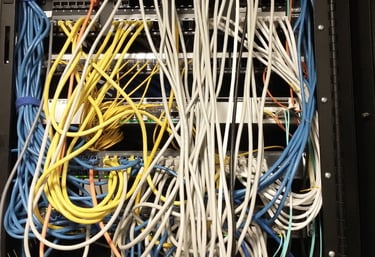 A mess of a cabling job in a network closet