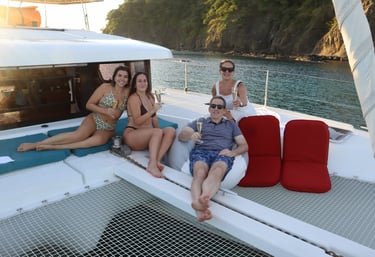 Guests relaxing with champagne on deck of luxury catamaran in Papagayo, Costa Rica