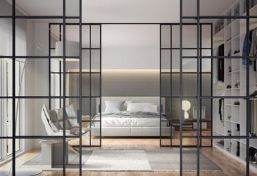 Puerta de vidrio corredera con marco negro en espacio diáfano entre salón y dormitorio contemporáneo