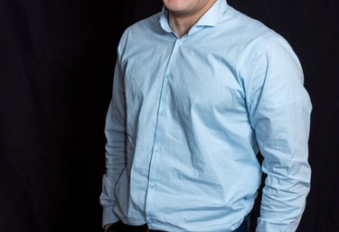 a man in a blue shirt and black pants