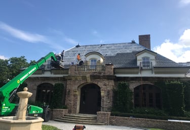 Roof tile material loaded using a lift due to the 10/12 pitch on the roof 