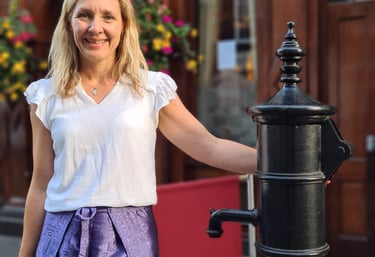 Dr Helena Seth-Smith standing at the John Snow water pump, London