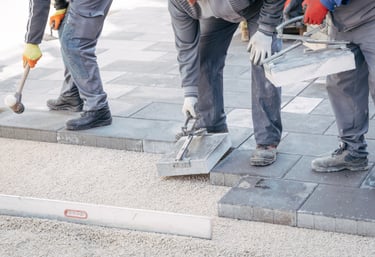 Professional paver installation in progress – Sarasota crew laying stone pavers with precision tools