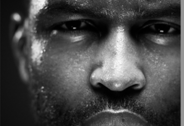 a man with a beard who is sweating