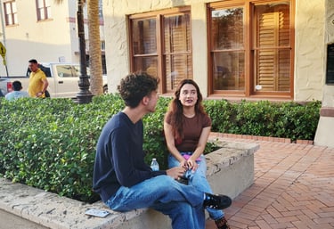 A young man next a girl talking