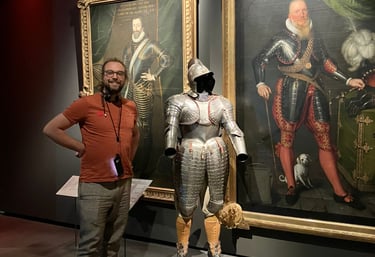 Image of Gabriele Culot in front of a suit of armour during a museum visit.