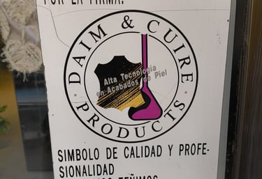 A sign that say that we're experts in leather and skins