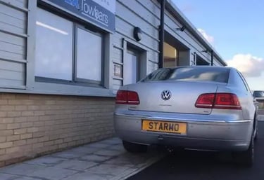 Volkswagen car parked outside Starmo Auto Electrics and Essex Towbars workshop in Braintree