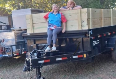 The owner, Sherieanne Skinner, and her daughter, Lily, on the Guaranteed Junk Removal dump trailer.