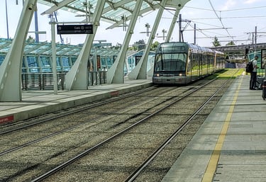 Metro train arriving at Porto Airport station with passengers boarding, showcasing the station platf