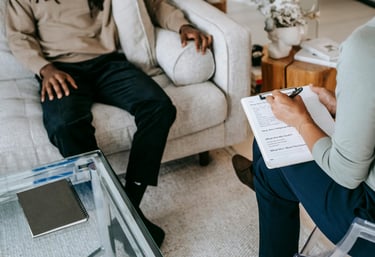 Person sitting down on a couch on therapy