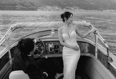a bride and groom on a boat in a lake como