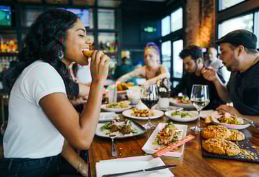 enjoying a delicious meal in a fancy restaurant, sharing with friends 