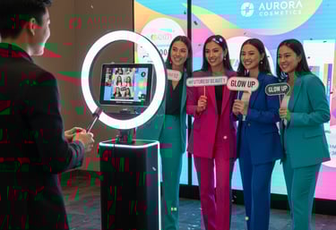 a group of people standing around a video screen