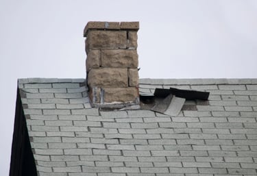 a chimney with a cap on top of a brick house