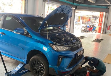 a man working on a car in a garage