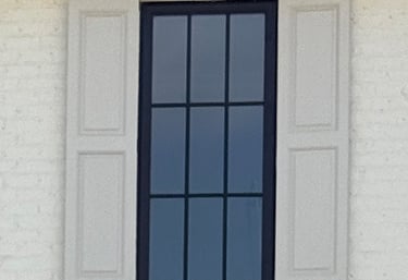 Fixed exterior shutters on a brick home