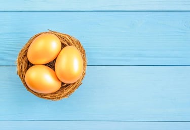 a basket of eggshells in a basket on a blue wooden table